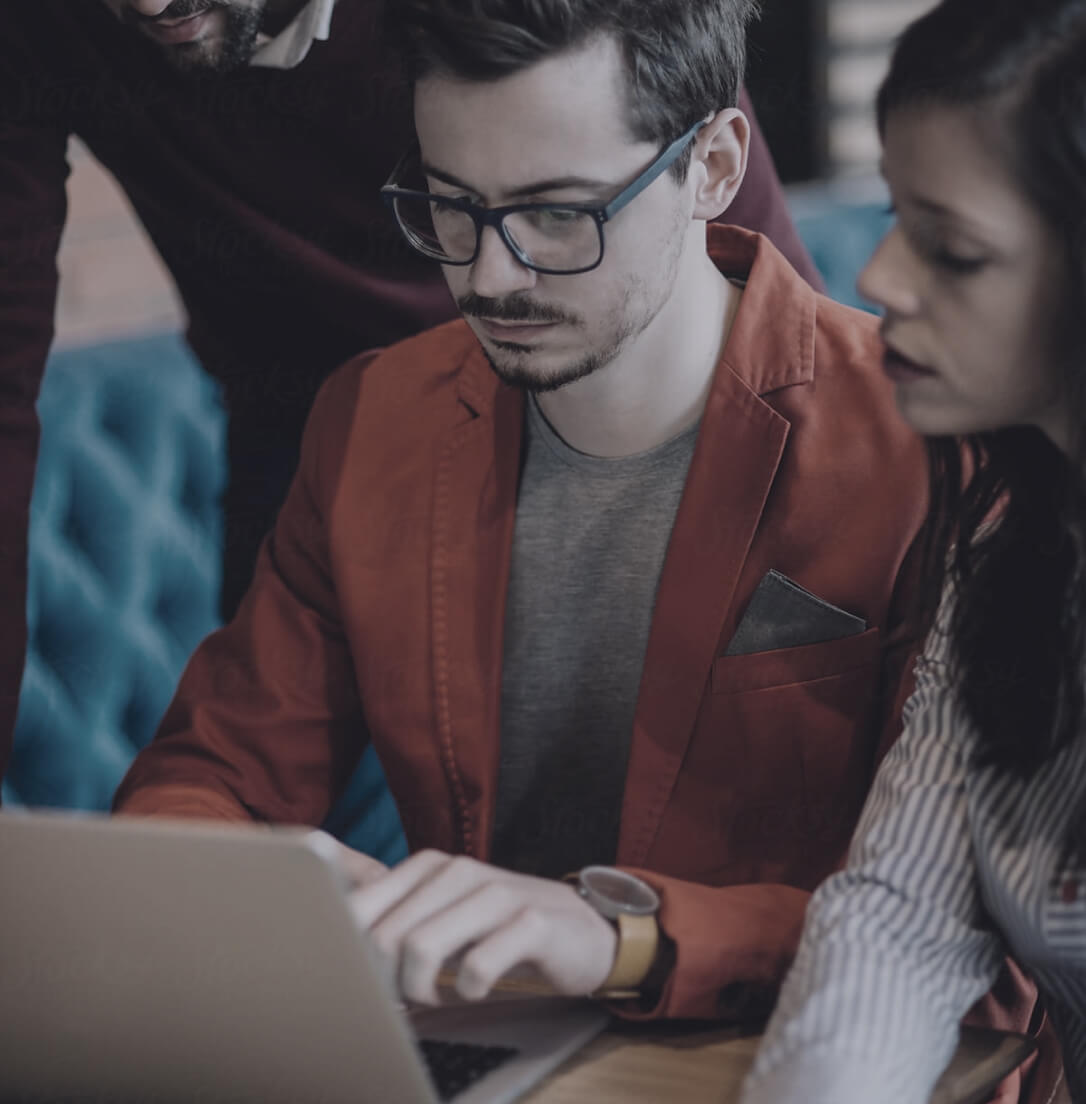 SureDrop secure file management system showing colleagues working on computer laptop